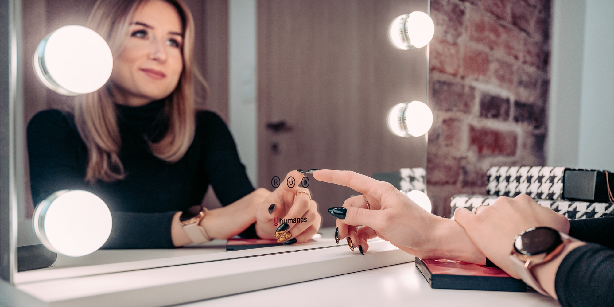 Young woman does her makeup in front of LED lighted mirror