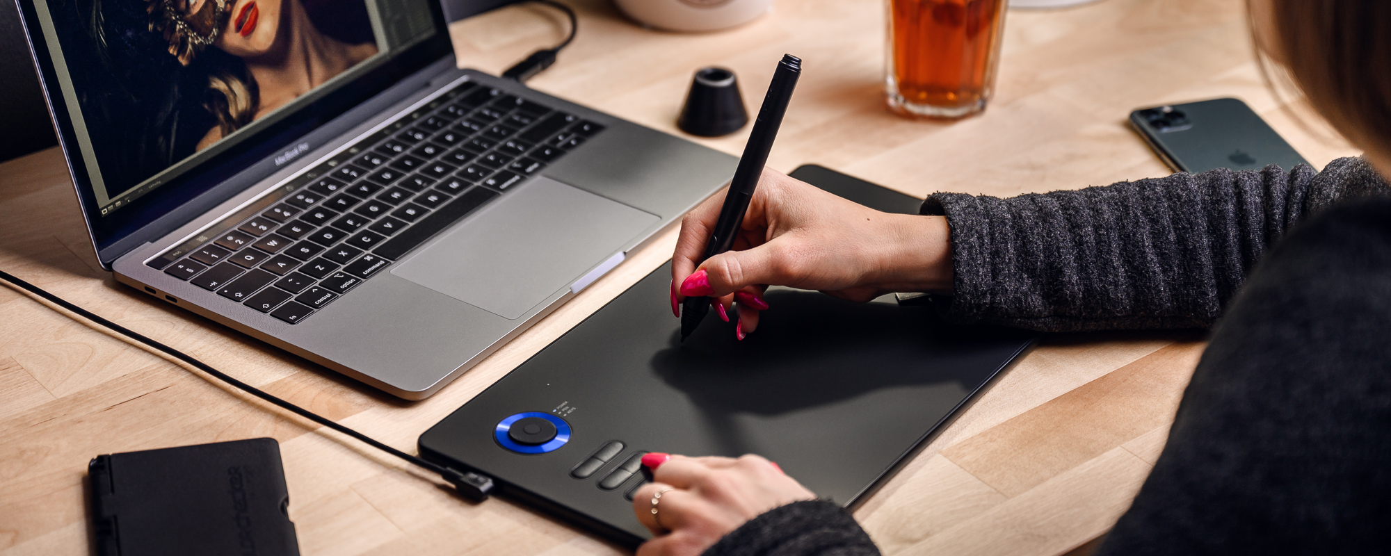 Photo - Veikk A15 Pro graphics tablet operated by a woman looking at the monitor while working